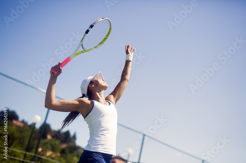 Beautiful female tennis player serving © NDABCREATIVITY
