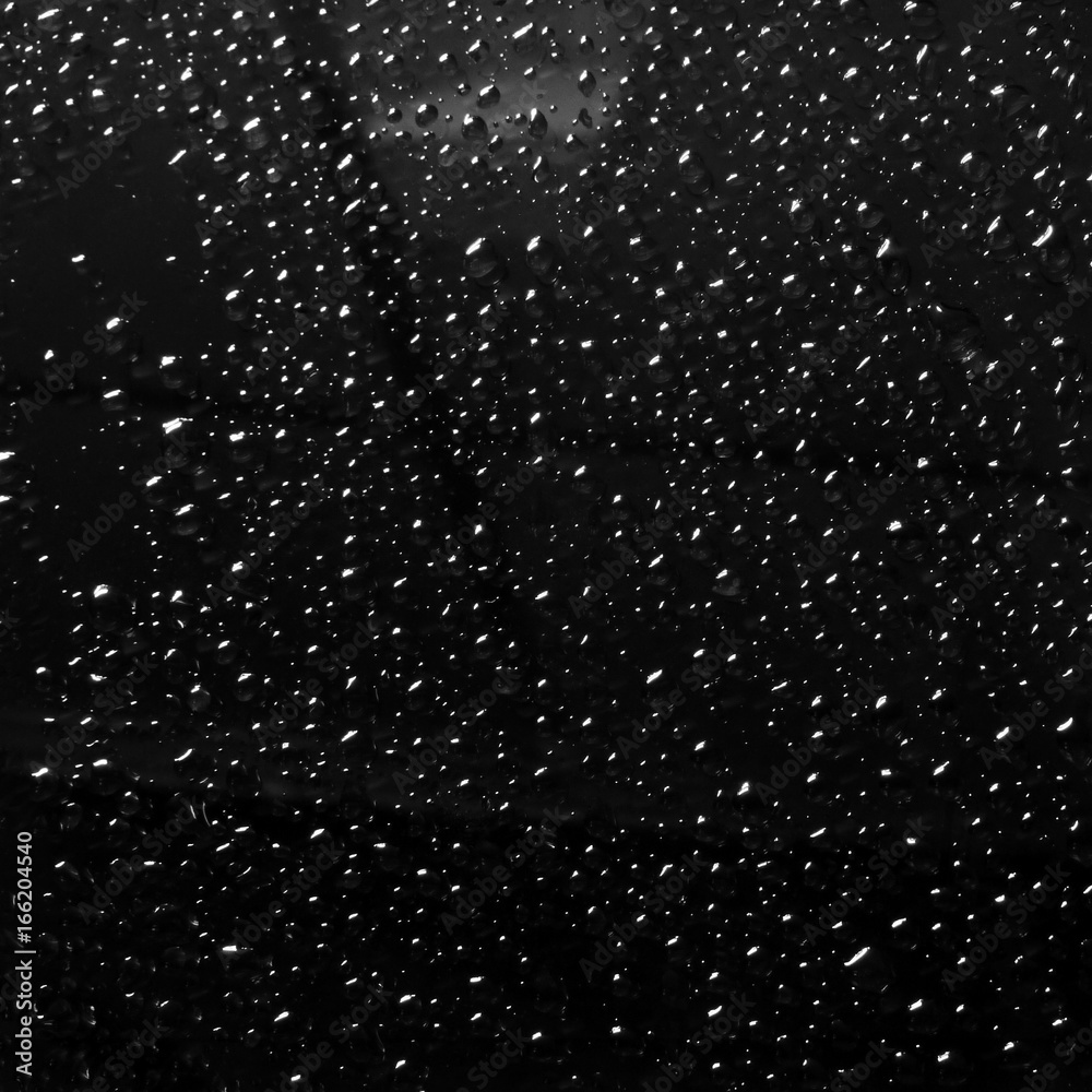 drops of rain on car window pane