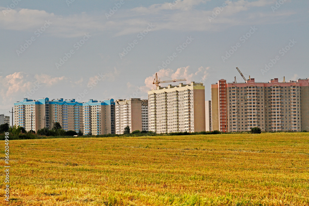 Fototapeta premium Residential buildings under construction in the field