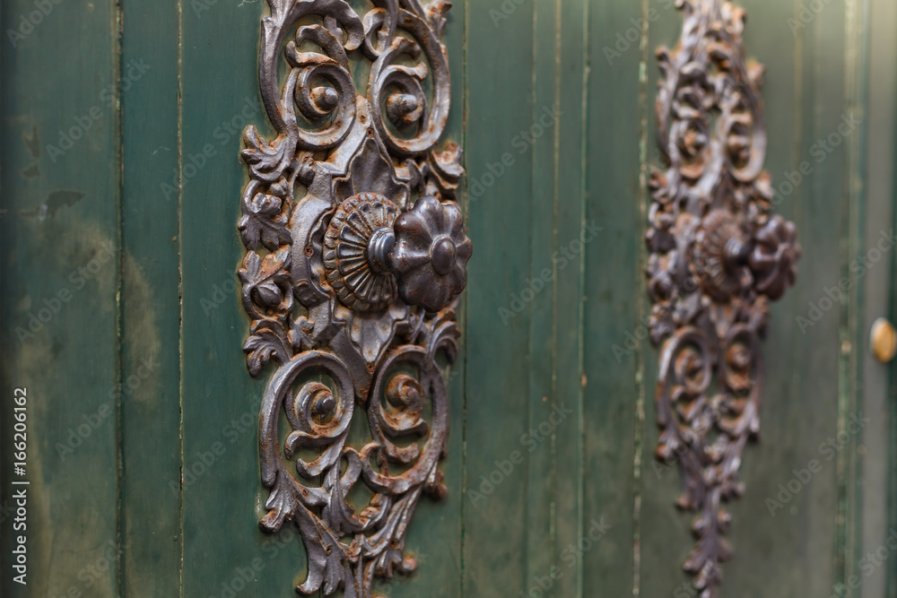 Detail of beautiful, ornate door knocker on an antique portal. Detail of beautiful, ornate door knocker on an antique portal.