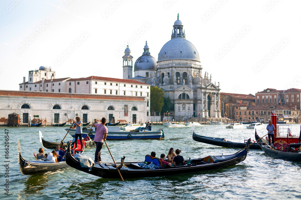 Venice, Italy - July 20 2017 : Gondola on Canal Grande with Basilica di Santa Maria della Salute in the background, Venice, Italy