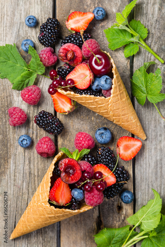 Fototapeta Naklejka Na Ścianę i Meble -  Selection of berries in ice cream cones - healthy dessert concept