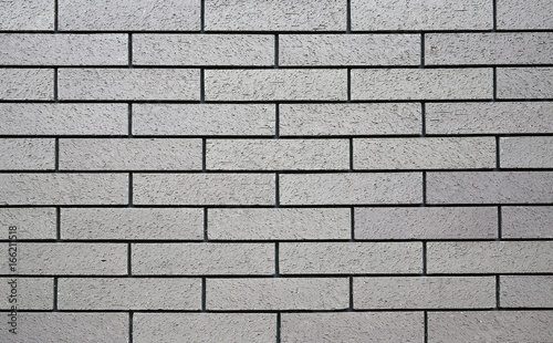 Horizontal grey brick wall background.