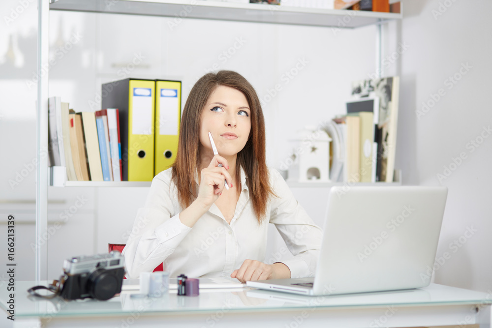 Young female designer using graphics tablet while working with computer Young female designer using graphics tablet while working with computer