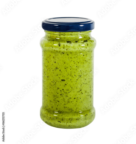 Pesto sauce in a glass jar isolated on white