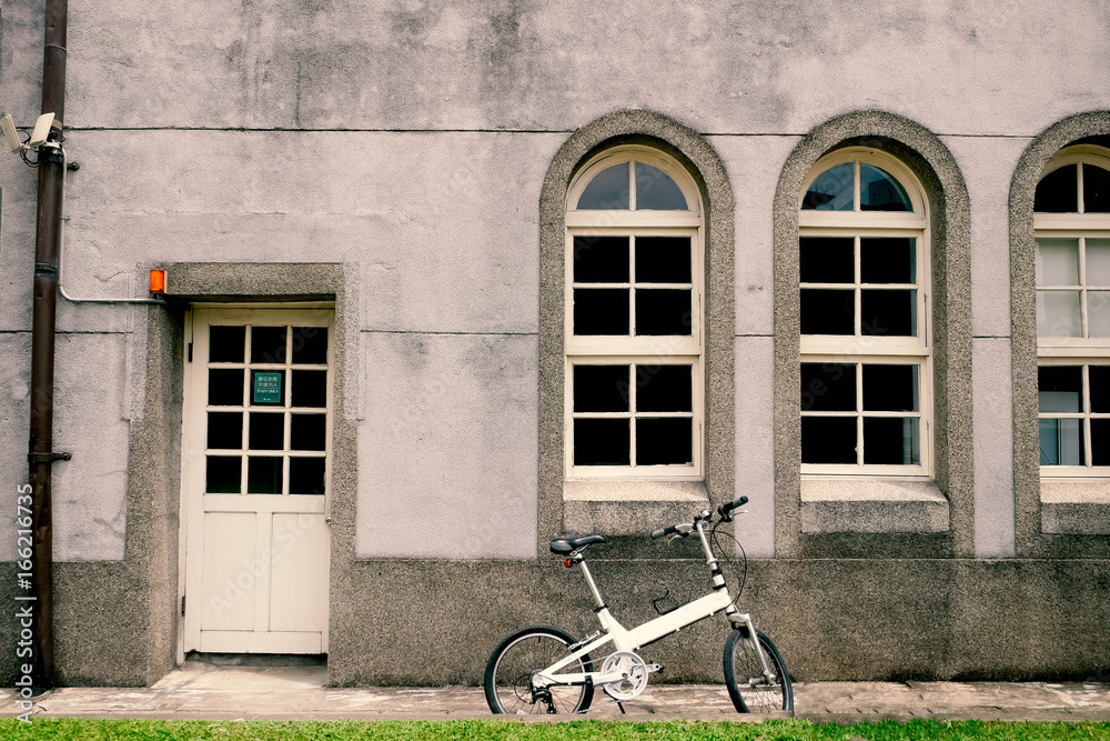White bike with vintage style building.