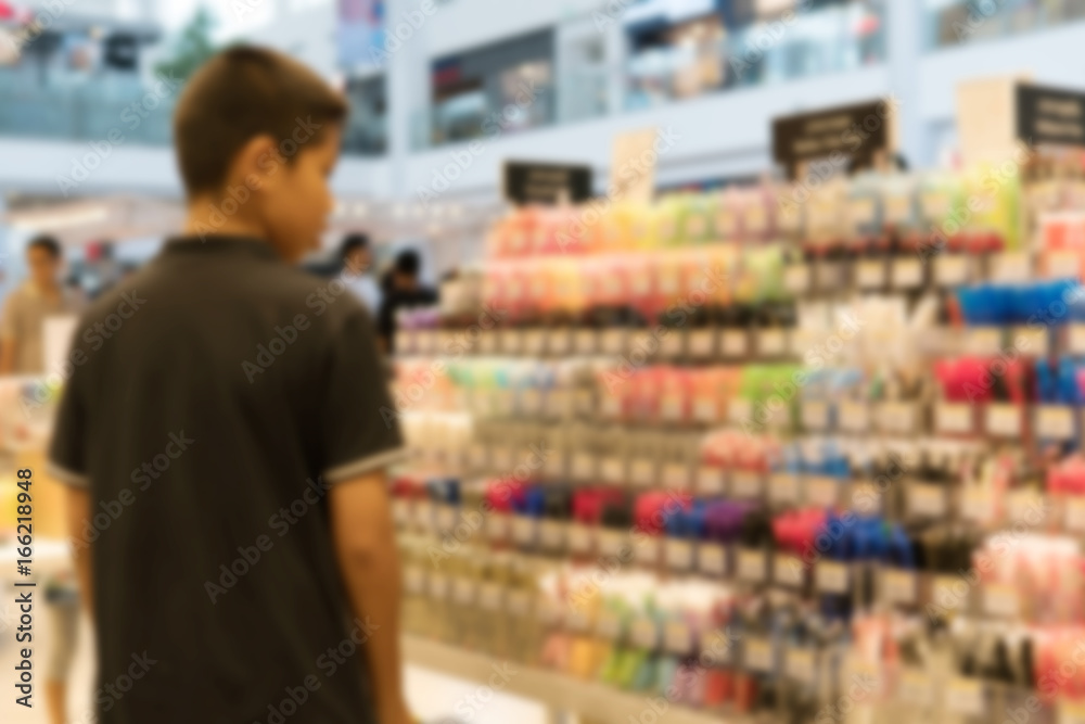 Blurry Background of Boy choose to buy the pen in the stationery store.