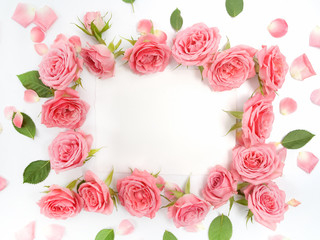 Framework from roses on white background. Flat lay, top view