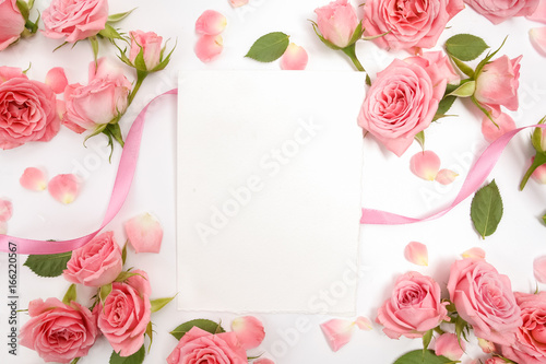 Framework from roses on white background. Flat lay, top view