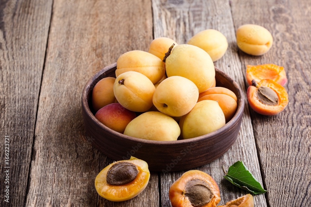 Ripe organic apricots on rustic wooden table Ripe organic apricots on rustic wooden table