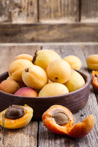 Ripe organic apricots on rustic wooden table