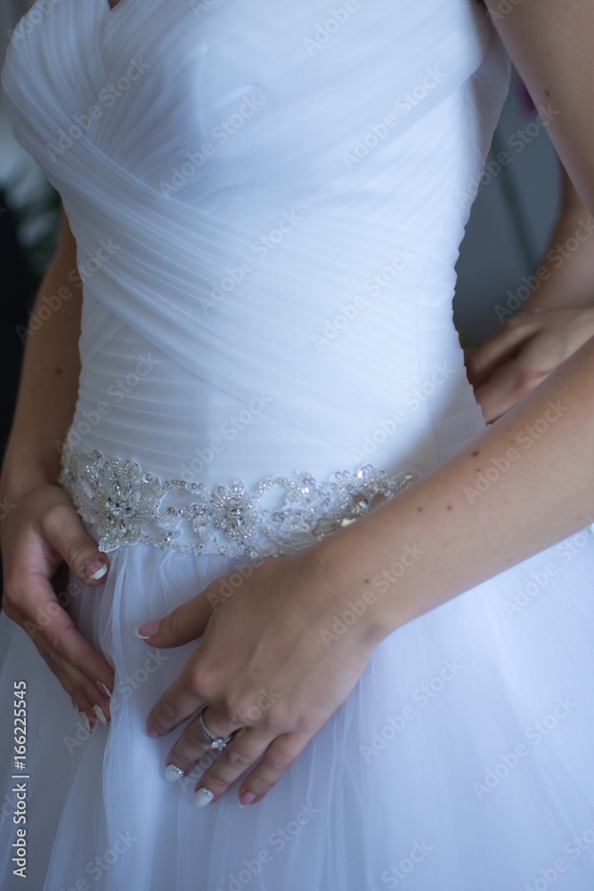 Bridesmaid preparing the bride for a big day Bridesmaid preparing the bride for a big day