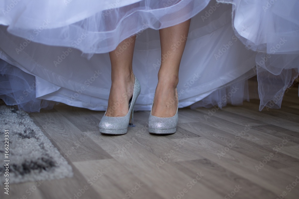 The bride in her dress is wearing beautiful boots The bride in her dress is wearing beautiful boots