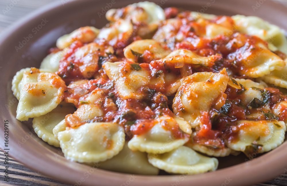 Portion of ravioli with marinara sauce Portion of ravioli with marinara sauce