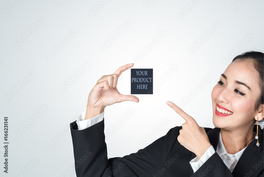 Business women smile holding empty hands and pointing at empty space for your product place here for promotion, product sales, and advertising ideas.