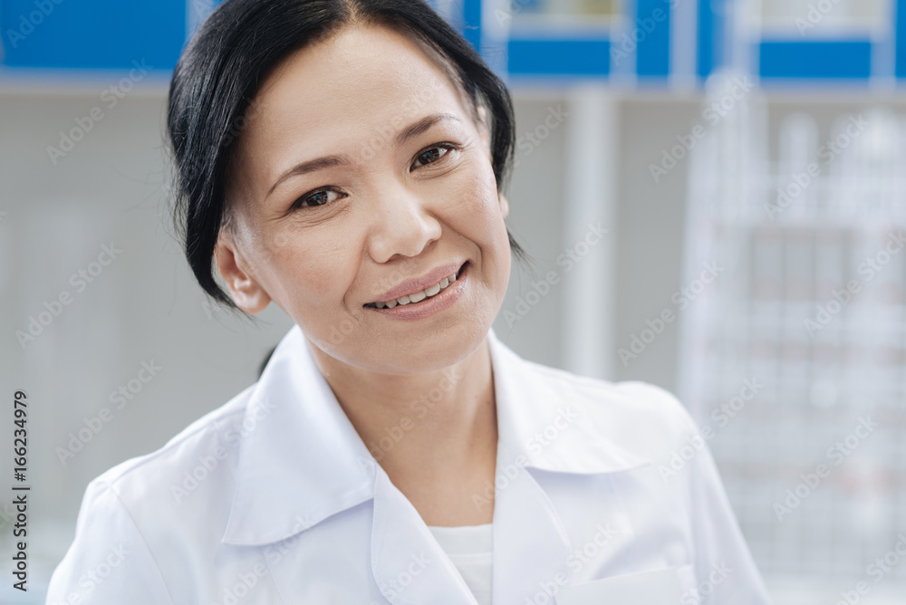 Joyful female doctor looking at you