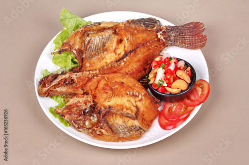 Deep fried Tilapia with spicy and sour herb salad .