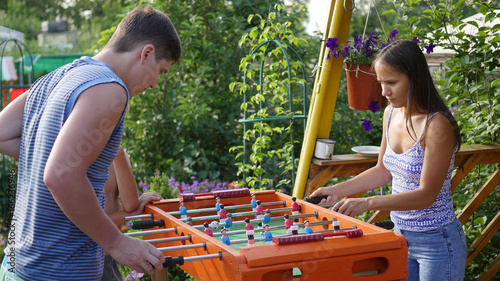 Family playing table football outdoors.Fun outdoors
