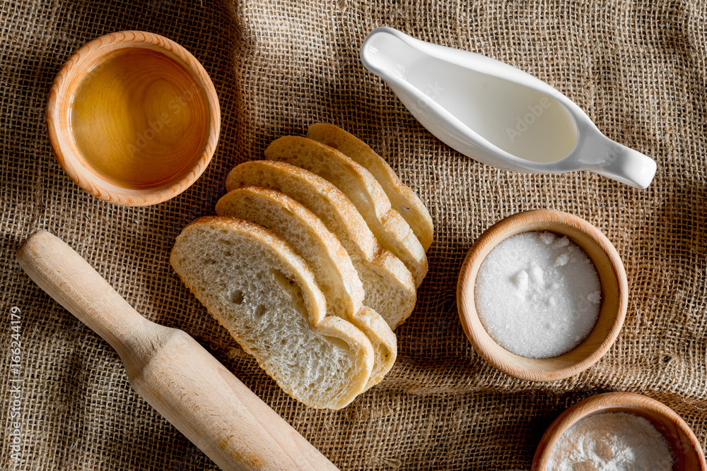 Homemade bread. Slices and ngredients on canvas background top view Homemade bread. Slices and ngredients on canvas background top view
