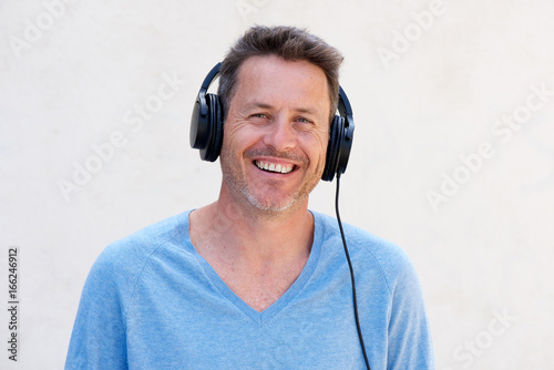 Close up cheerful man with headphones listening to music