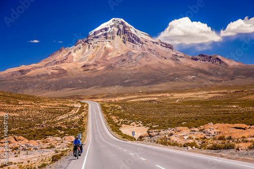 Cycling on the beautiful road in front of Nevado Sajama volcano photo