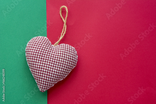 Christmas decorative hanging heart on a multicolored background