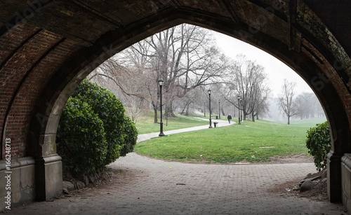 View through the arch in foggy day in the Brooklyn park, New York landscape.
