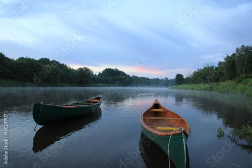 canoe on river in canada sunrise