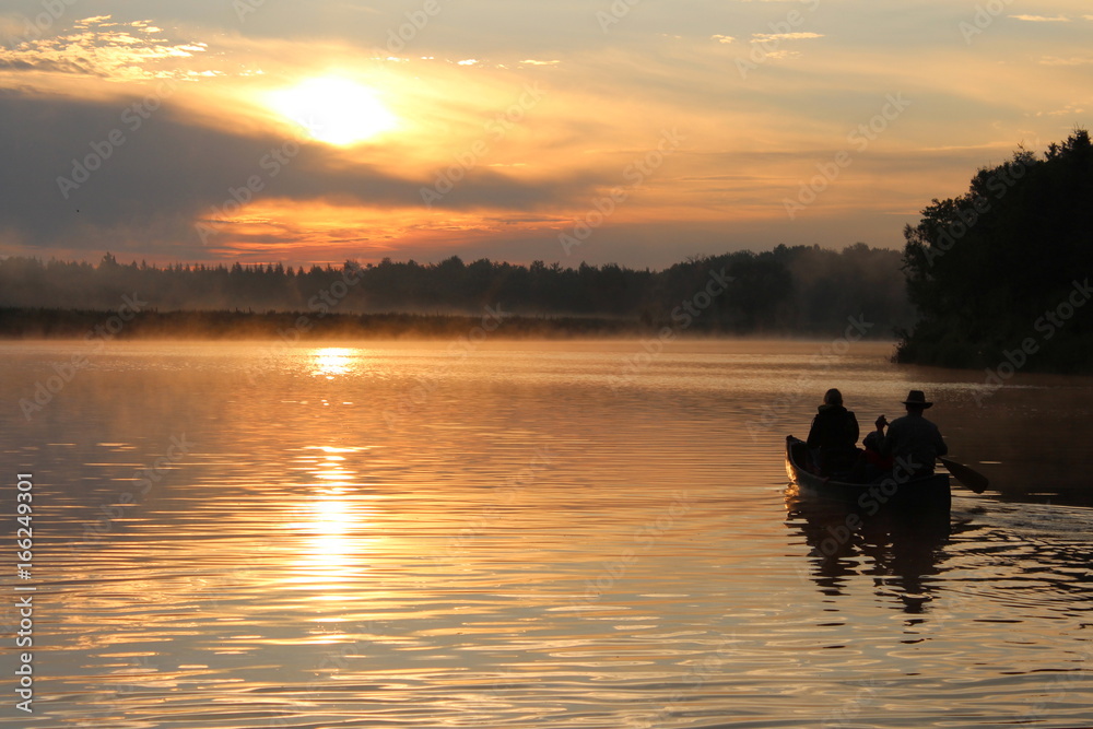 sunrise river silhouette in canoe