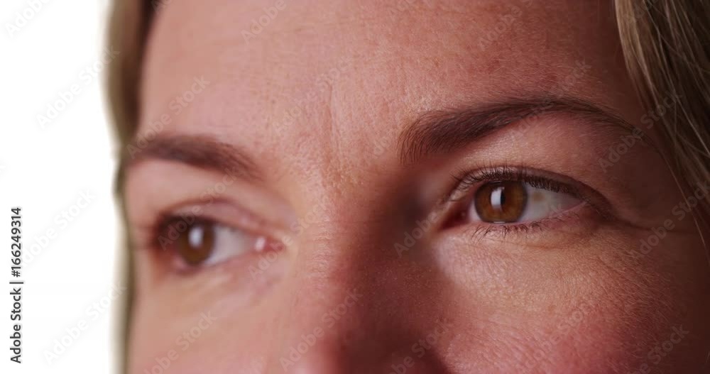 Extreme close up of middle aged Caucasian woman's eyes on white background Extreme close up of middle aged Caucasian woman's eyes on white background