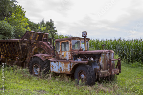 Rusting farm truck in field