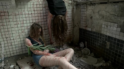 Bloody women are unconscious in the old building