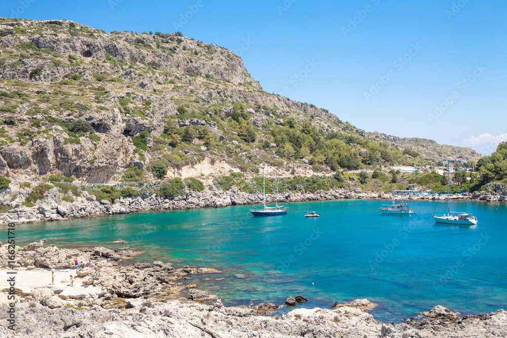 Beach off the coast of the island of Rhodes in Greece. Seaside landscape. Rocky coast and sea.