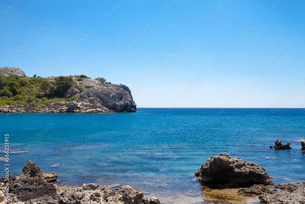 Beach off the coast of the island of Rhodes in Greece. Seaside landscape. Rocky coast and sea. Beach off the coast of the island of Rhodes in Greece. Seaside landscape. Rocky coast and sea.