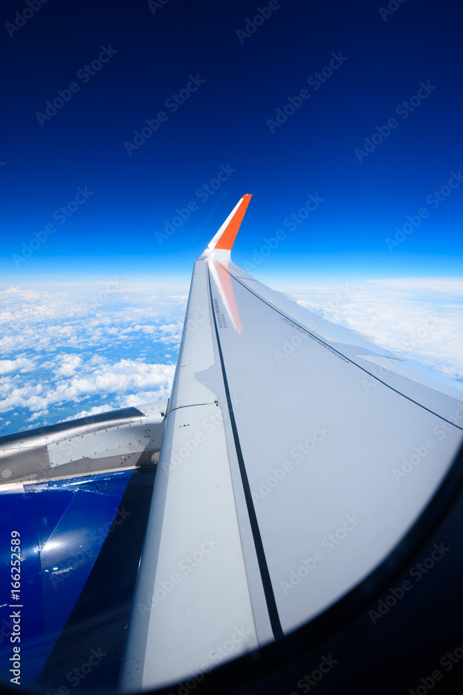 Obraz premium Airplane over clouds