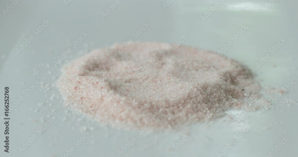 Pink Himalayan salt on a white plate as a healthy cooking ingredient. Pink Himalayan salt on a white plate as a healthy cooking ingredient.