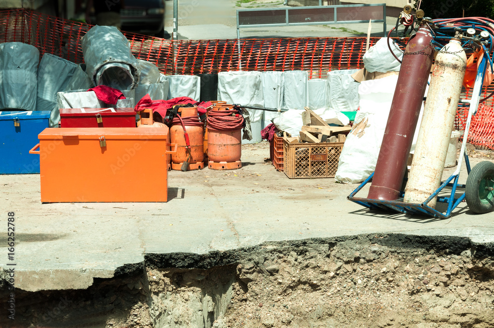 Welding gas tanks on the trolley, butane and metal tool boxes with