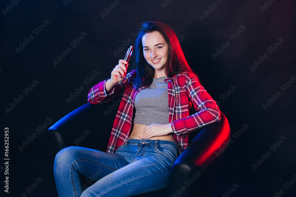 Fototapeta premium Woman smoking electronic cigarette with smoke
