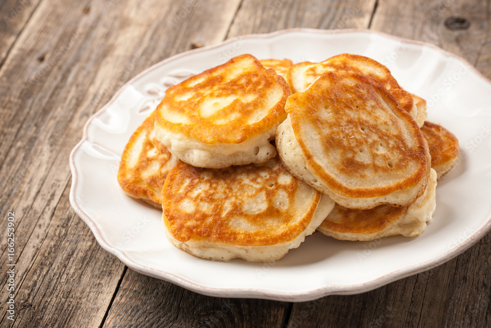 Homemade pancakes in a plate on wooden table Homemade pancakes in a plate on wooden table