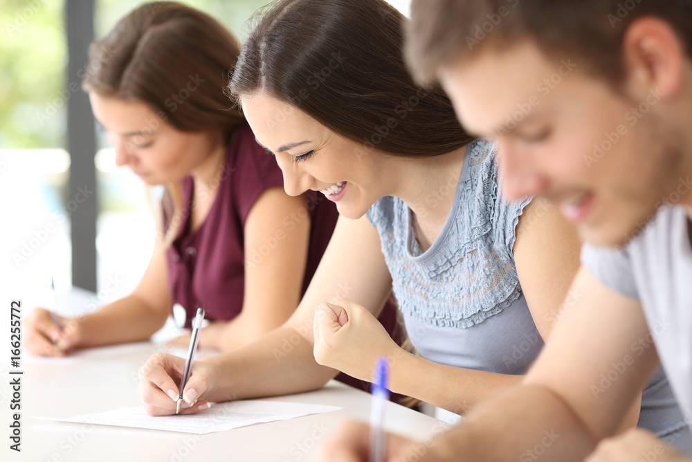 Excited student during an exam at classroom Excited student during an exam at classroom