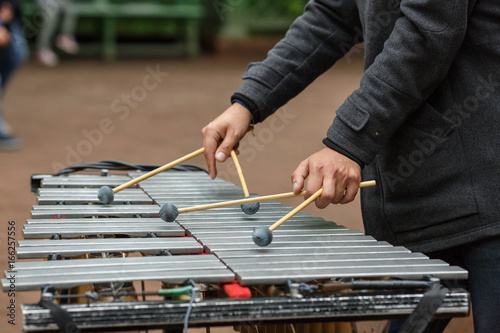 Hands of street musician playing the chromatic glockenspiel (metallophone) photo