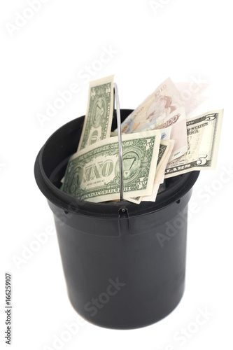 bucket with money over white background