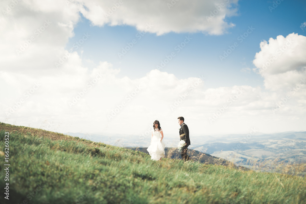 Beautiful gorgeous bride posing to groom and having fun, luxury ceremony at mountains with amazing view, space for text, wedding couple Beautiful gorgeous bride posing to groom and having fun, luxury ceremony at mountains with amazing view, space for text, wedding couple
