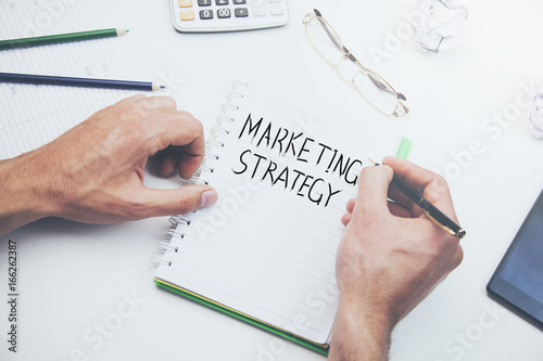 Marketing strategy text on notepad