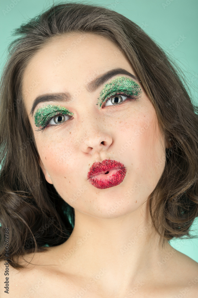 fun girl with bright cosmetics on green background fun girl with bright cosmetics on green background