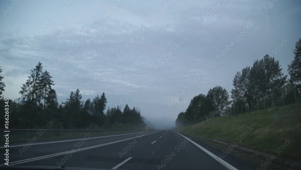 Point of view driving,dashboard camera,on a dark rainy foggy mountain road with limited visibility with windshield wipers on. Point of view driving,dashboard camera,on a dark rainy foggy mountain road with limited visibility with windshield wipers on.