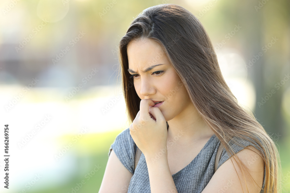 Nervous girl biting nails outside Nervous girl biting nails outside
