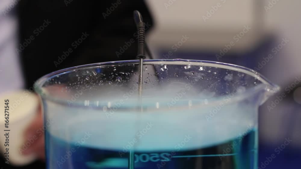 Mixing Of The Liquid In The Tube. Colored Medical tubes mix with the aid of a special device. Medical mixer. Mixing Of The Liquid In The Tube. Colored Medical tubes mix with the aid of a special device. Medical mixer.