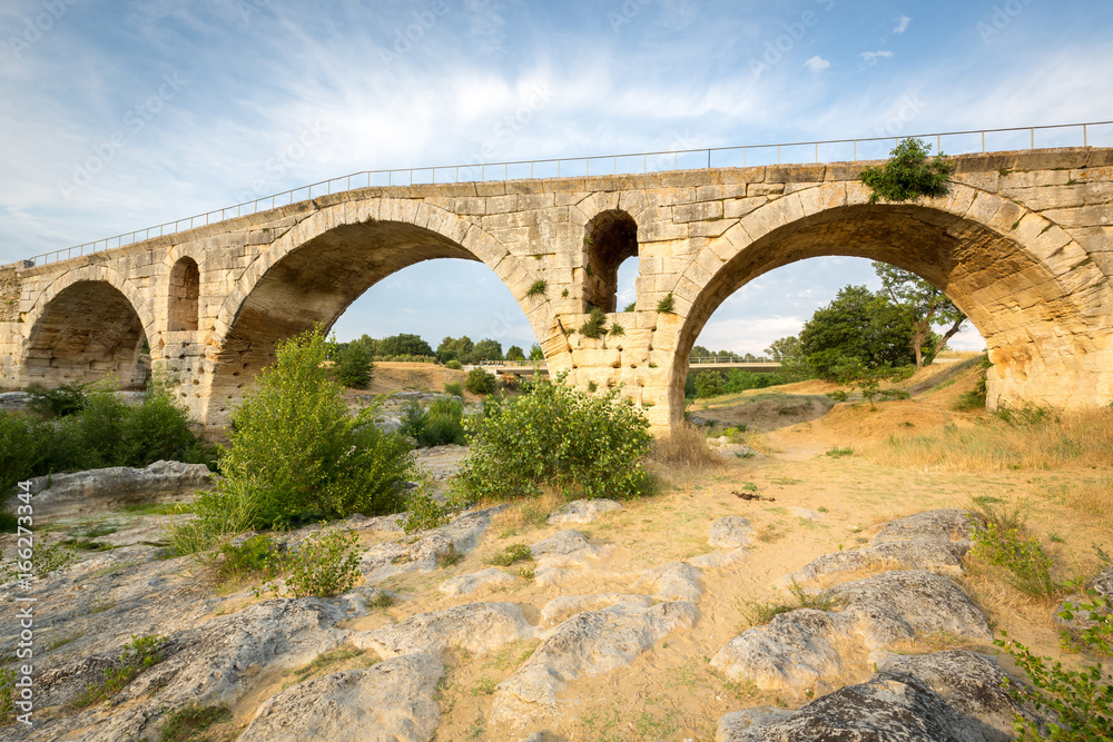 Pont Julien - circa 2000 years old Roman stone arch bridge over the Calavon river, Provence, France