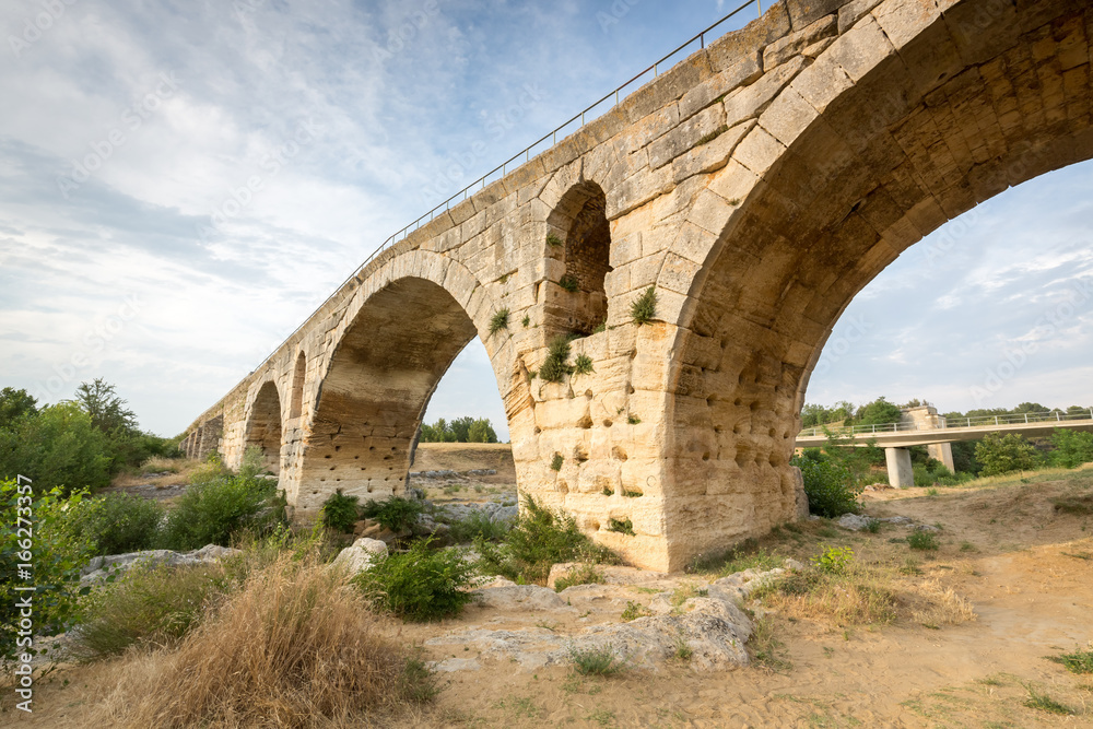 Pont Julien - circa 2000 years old Roman stone arch bridge over the Calavon river, Provence, France